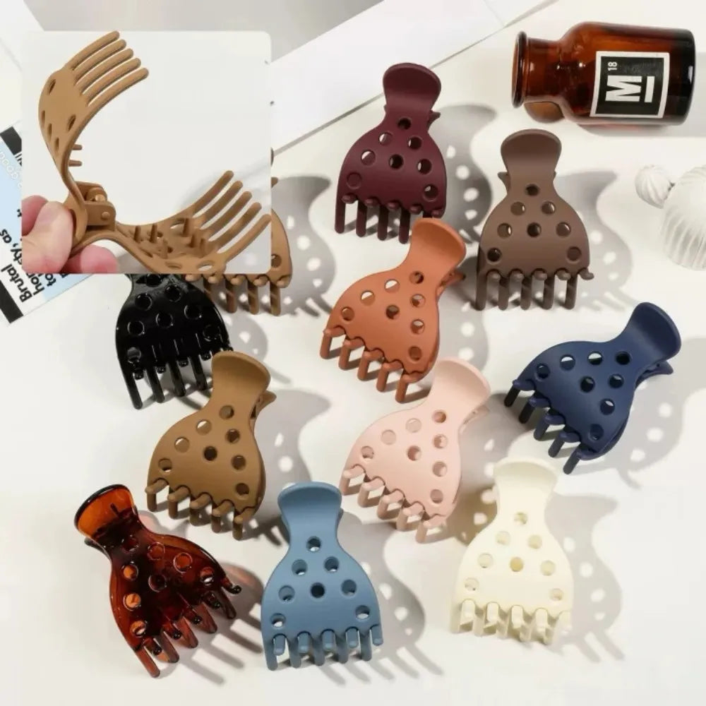 A collection of various hair clips designed for root lifting, including silicone and plastic options in brown, black, pink, b