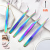A set of five precision stainless steel eyelash tweezers with iridescent purple and blue finishes displayed on a white marble