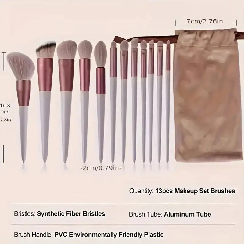 A set of 13 professional makeup brushes with synthetic fiber bristles and aluminum tubes displayed on a wooden stick.