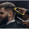 A man is having his hair styled with a professional rotary hair clipper.