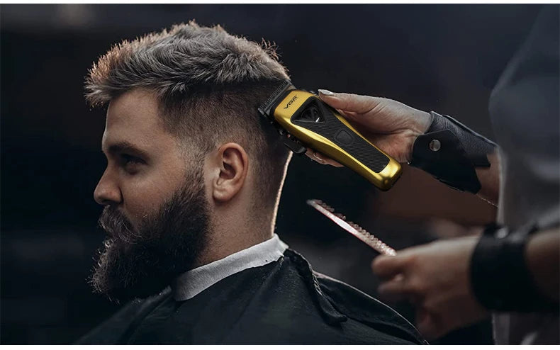 A man is having his hair styled with a professional rotary hair clipper.