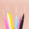 A collection of various colored precision eyebrow and lash brush sets displayed against a light pink background.