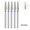 A set of five silver diamond nail drill bits with varying sizes shown next to a scale.