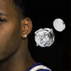 Silver crystal magnetic stud earrings for men displayed on a person's ear.