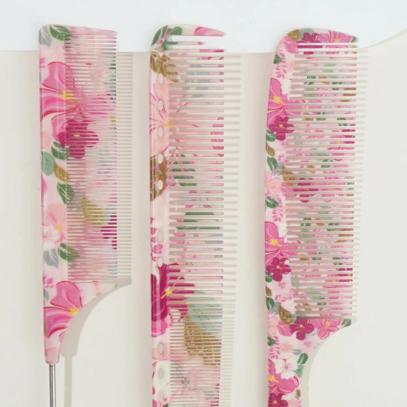A set of three pink floral hair combs with clear plastic teeth for styling