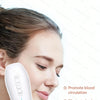 A person is using a white EMS fat cellulite massager device on their face.
