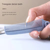 A hand holds a light blue triangular dense tooth hairbrush with anti-static bristles on a white surface.