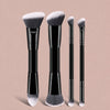 A set of six black and silver dual-ended makeup brushes displayed against a light pink background.