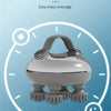 A silver portable electric scalp massager is shown within a circular clock graphic, illustrating auto timing features.
