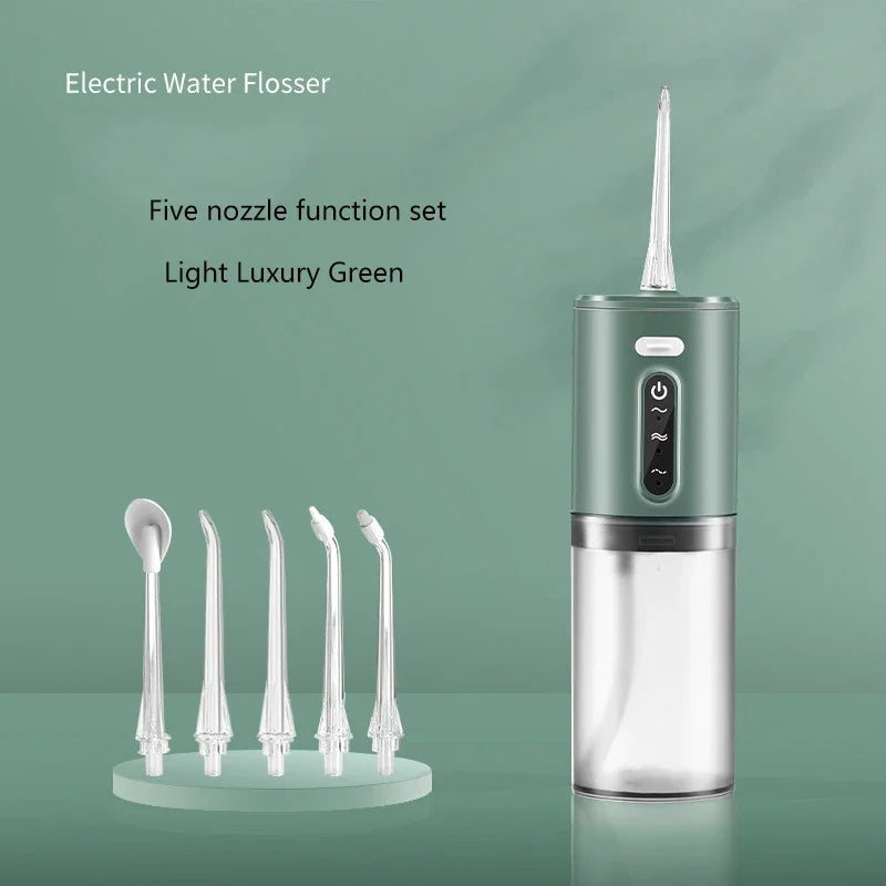 A light luxury green electric water flosser with five nozzle tips displayed next to the device.