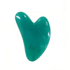 Masajeador facial de cera de abeja en forma de corazón, color verde azulado.