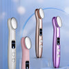 A collection of three rose gold and purple eye massage instruments displayed on a light blue background.