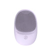 A white silicone sonic facial cleansing brush with a textured head and a power button.
