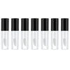 A row of twelve clear glass lip gloss tubes with black caps arranged horizontally.