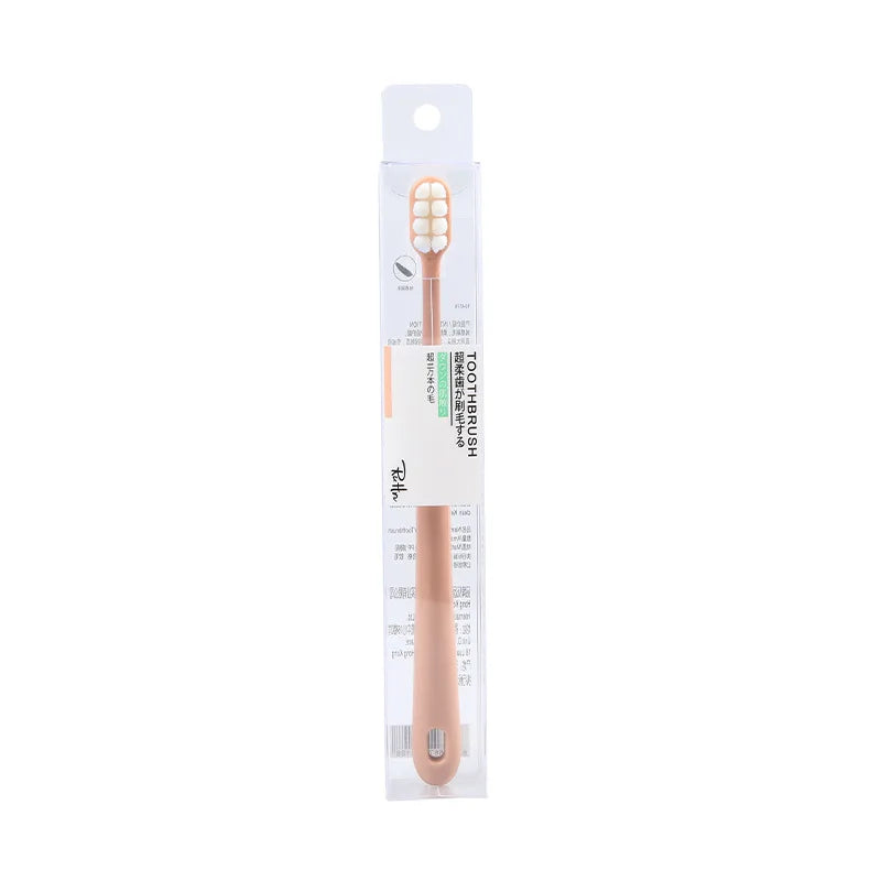A packaged soft bristle toothbrush set for sensitive gums with a light pink handle and white bristles.