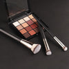 A professional makeup brush set with various shades of foundation and concealer brushes displayed in an open compact case.