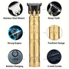 A gold-colored electric hair clipper featuring a dragon design, showing various features like sharp teeth and bottom charging