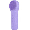 A purple electric facial cleansing and massage brush with a silicone head and power button.