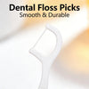 A white reusable dental floss pick shown against a light background.
