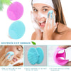 A woman is using a silicone facial cleansing brush set to apply foam onto her face.