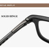 Detail display of a solid hinge on reading glasses frame.