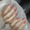 A close-up of a hand displaying 24Pcs Pink Flower Almond press on nails with a sheer pink and glitter finish.