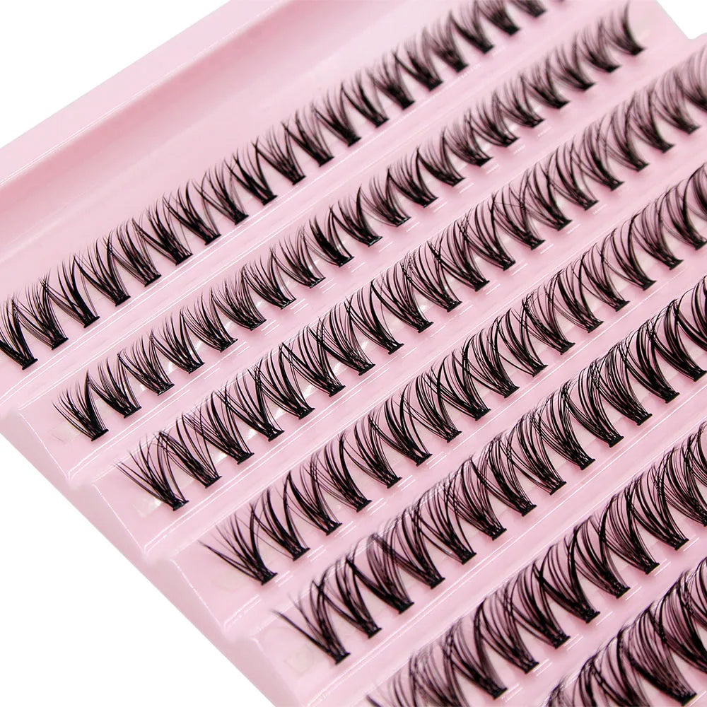 A pink lash tray containing a set of black DIY cluster lashes for volume extensions.