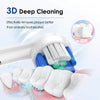 A white electric toothbrush is shown cleaning teeth, with toothpaste residue visible on the teeth and bristles.