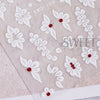 White embossed floral nail stickers featuring small red accents on a translucent background.