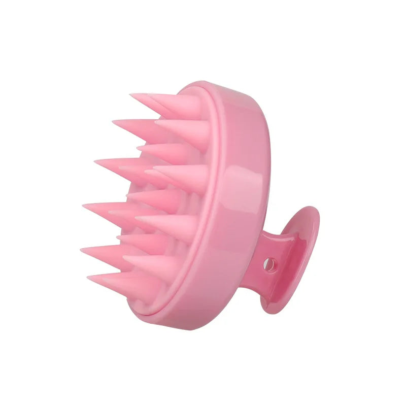A pink silicone scalp massage and body brush with numerous pointed bristles.