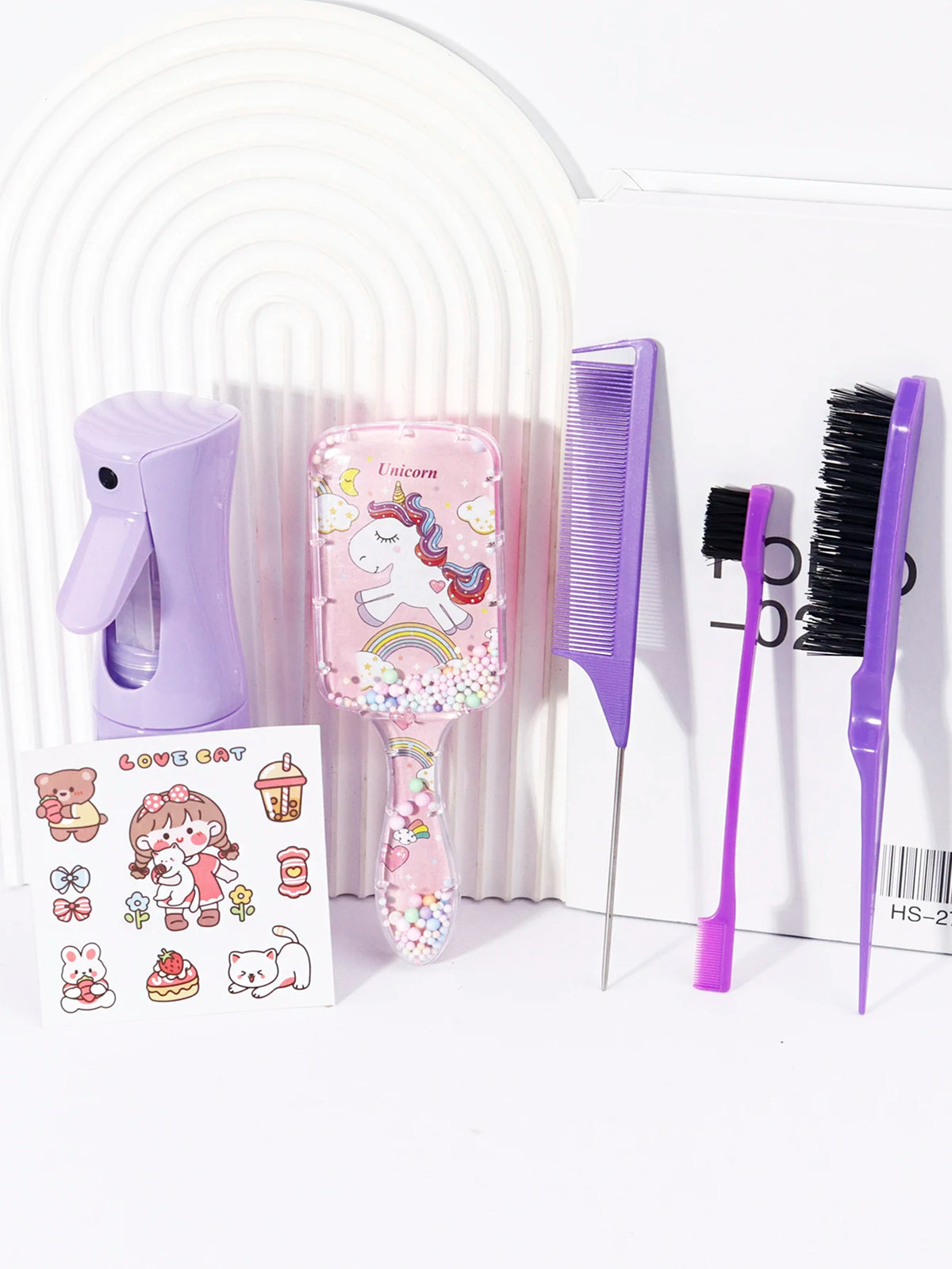 A purple hair styling kit featuring a hair dryer, comb, and brush with unicorn designs.