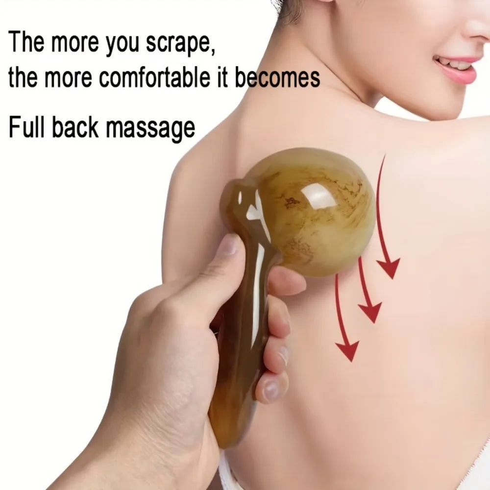 A hand applies a golden resin gua sha tool to the neck and shoulder area for massage.