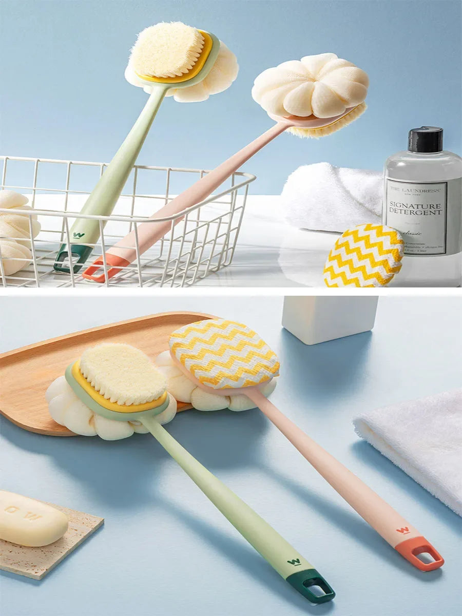 A long-handle loofah back scrubber with a soft mesh sponge in light green and peach tones is shown alongside a white towel an