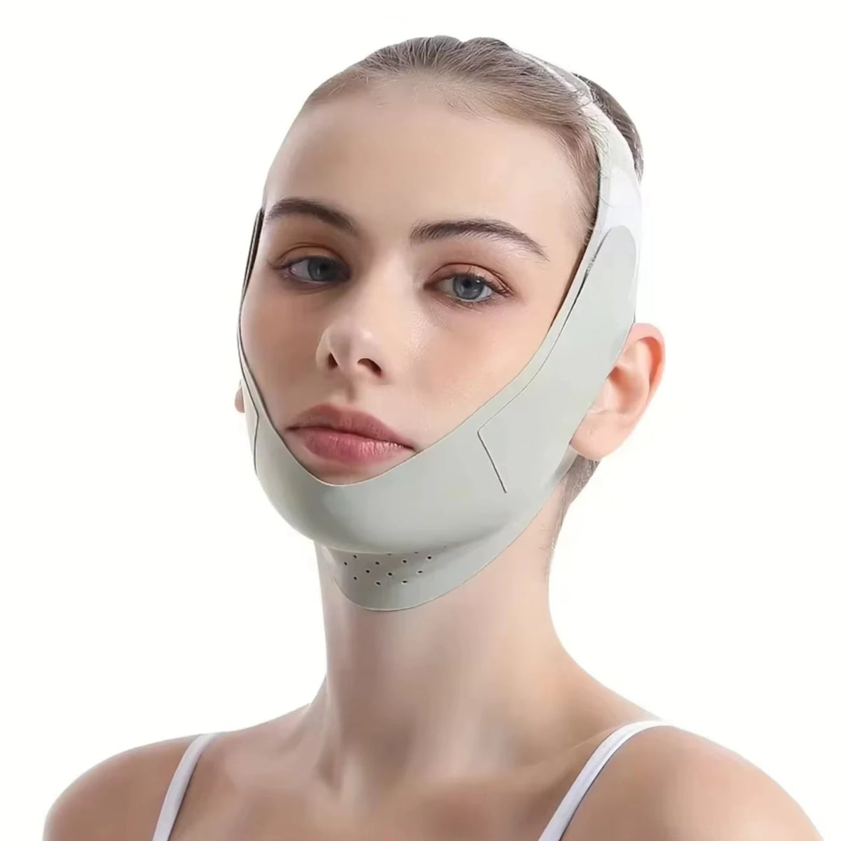 A woman wearing a beige facial lifting strap designed for contour definition.