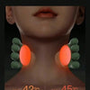 Close-up of a person's neck showing an orange heat applicator device being used for massage.