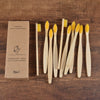 A set of ten natural bamboo toothbrushes packaged in brown cardboard box.