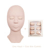 A realistic silicone mannequin head for eyelash extension practice with a box of individual lashes.