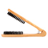 A wooden double-sided hair comb with black bristles shown in profile.