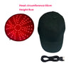 A black cap with a circular red LED light panel on top and an attached power cord.