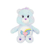 A light blue classic care bears plush stuffed animal doll with a purple nose and a rainbow heart design on its chest.