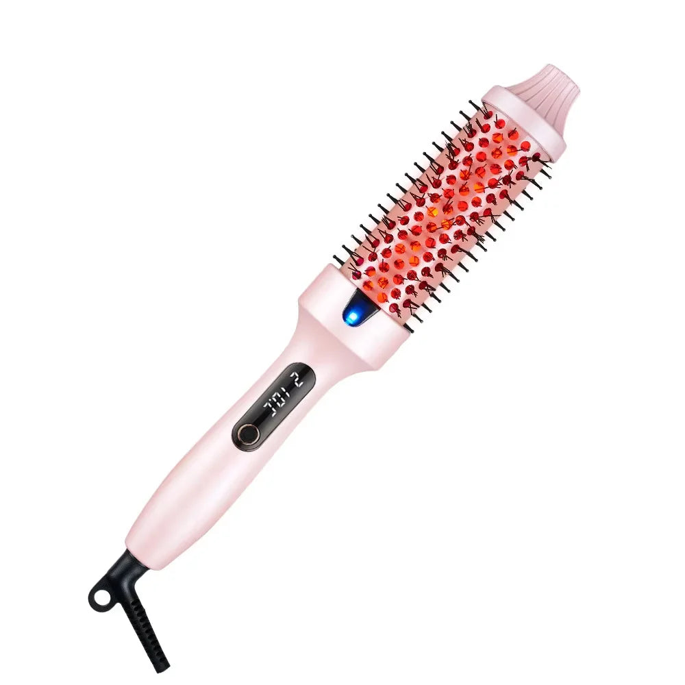 A pink professional heated round hair brush with red bristles and a black handle.