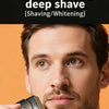 A man is holding a portable rechargeable electric foil shaver near his jawline for a deep shave.