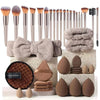 A collection of professional makeup brushes and sponges in various shades of brown and beige.