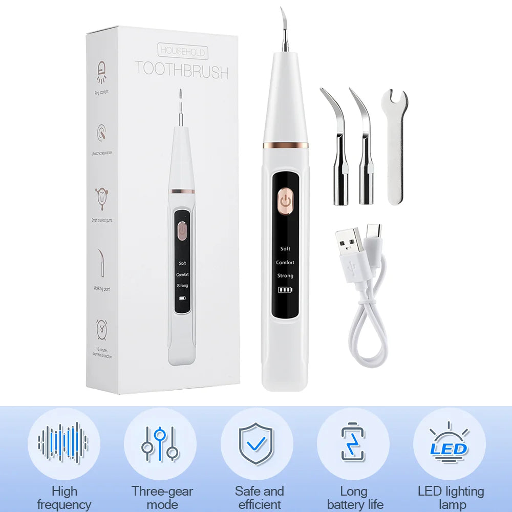 A white ultrasonic dental scaler kit including a handheld brush, cleaning tools, and charging cable.
