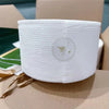 A white, textured disposable face towel is shown in a cardboard box.