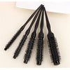A set of five black professional curly round hair combs with elastic teeth displayed on a light surface.