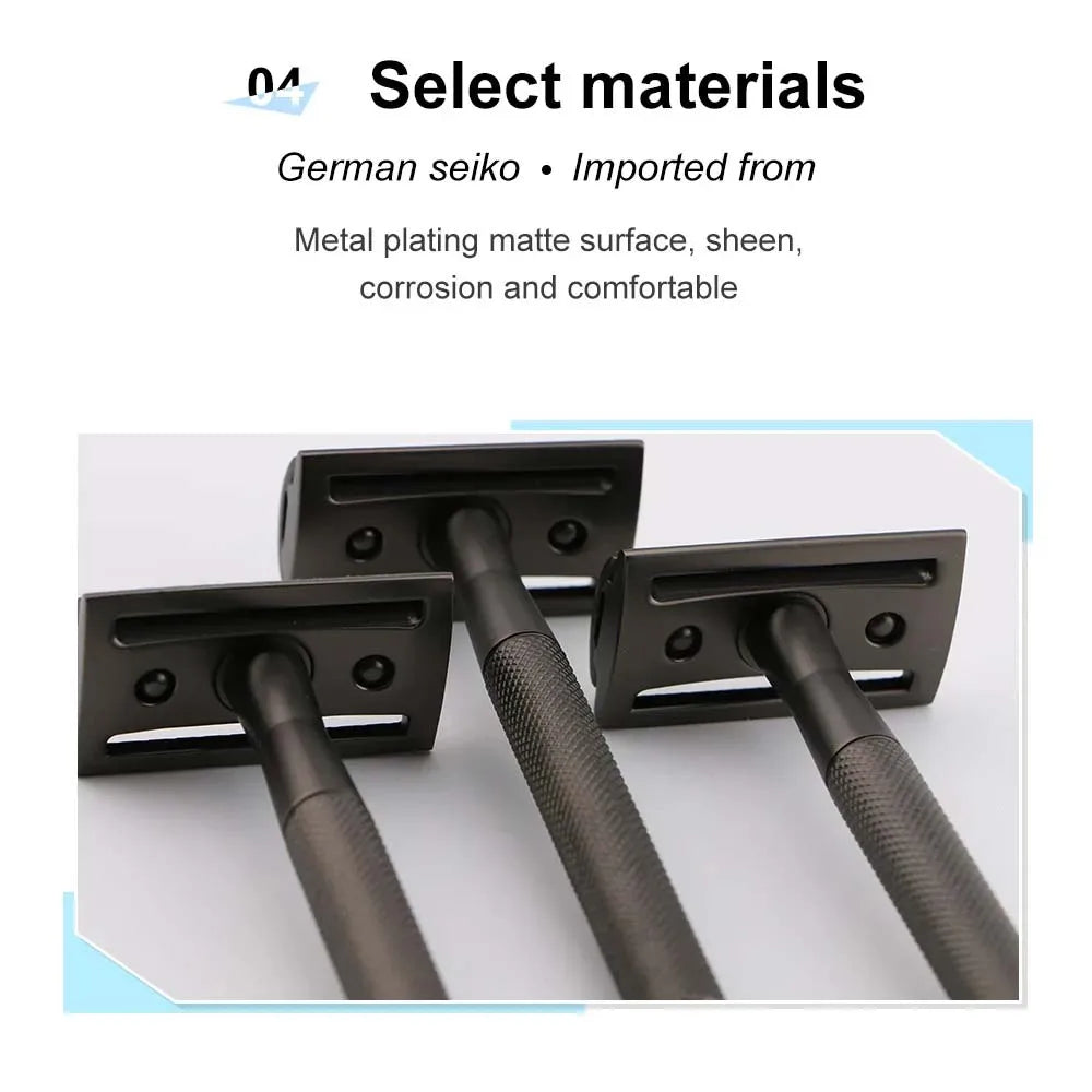 Black metal safety razor handles and plates shown in a close-up view.