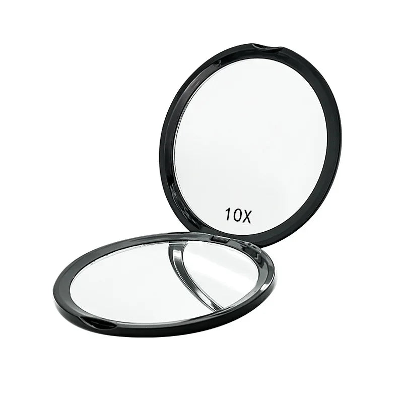 A portable magnifying makeup mirror with a round lens and a hinged cover.