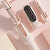 A set of white automatic rotating ceramic hair curling irons displayed on a pink background.