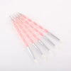 A set of five pink silicone dotting pens with stainless steel tips arranged diagonally on a white background.
